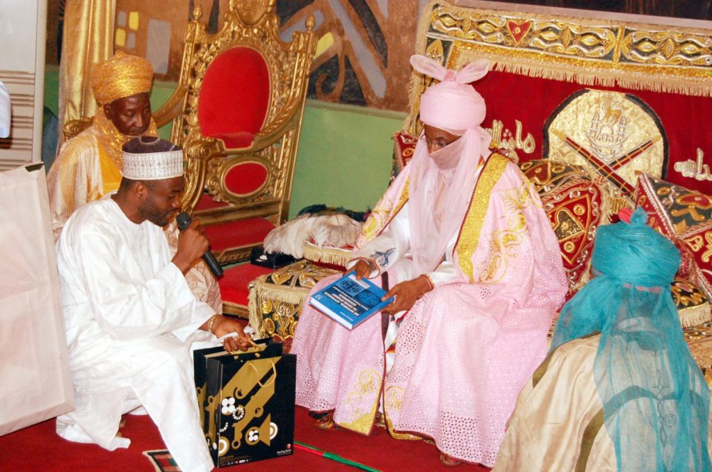 Basheer Oshodi presenting the book to the Emir of Kano, Nigeria